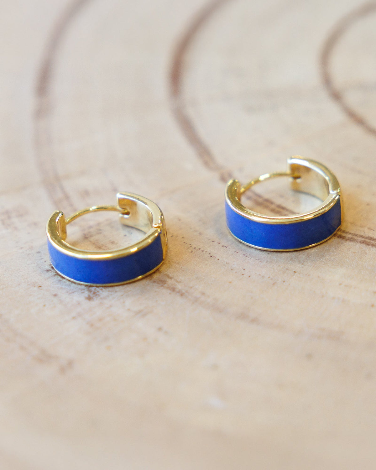 Downeast Blue Moon Huggie Hoops earrings featuring small, sleek blue moon-shaped hoops for a stylish jewelry look