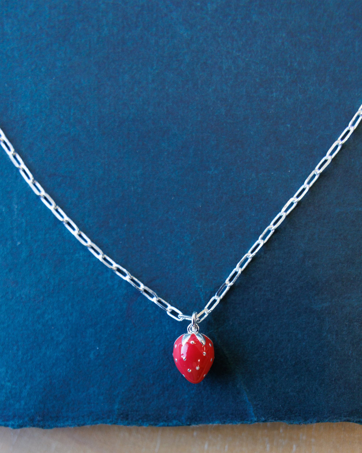 Silver Strawberry Fields Forever necklace by Downeast featuring a delicate strawberry charm on a sleek chain.