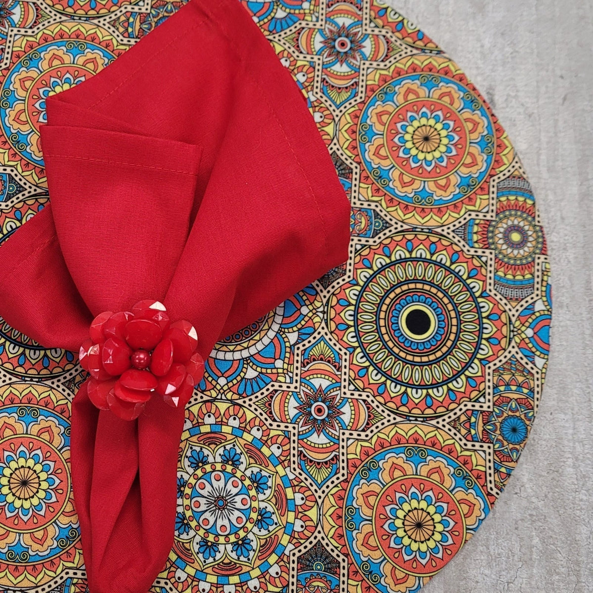 Set of four Maison Charlo round MDF wood placemats with colorful mandala Psychedelic designs, 14-inch diameter.