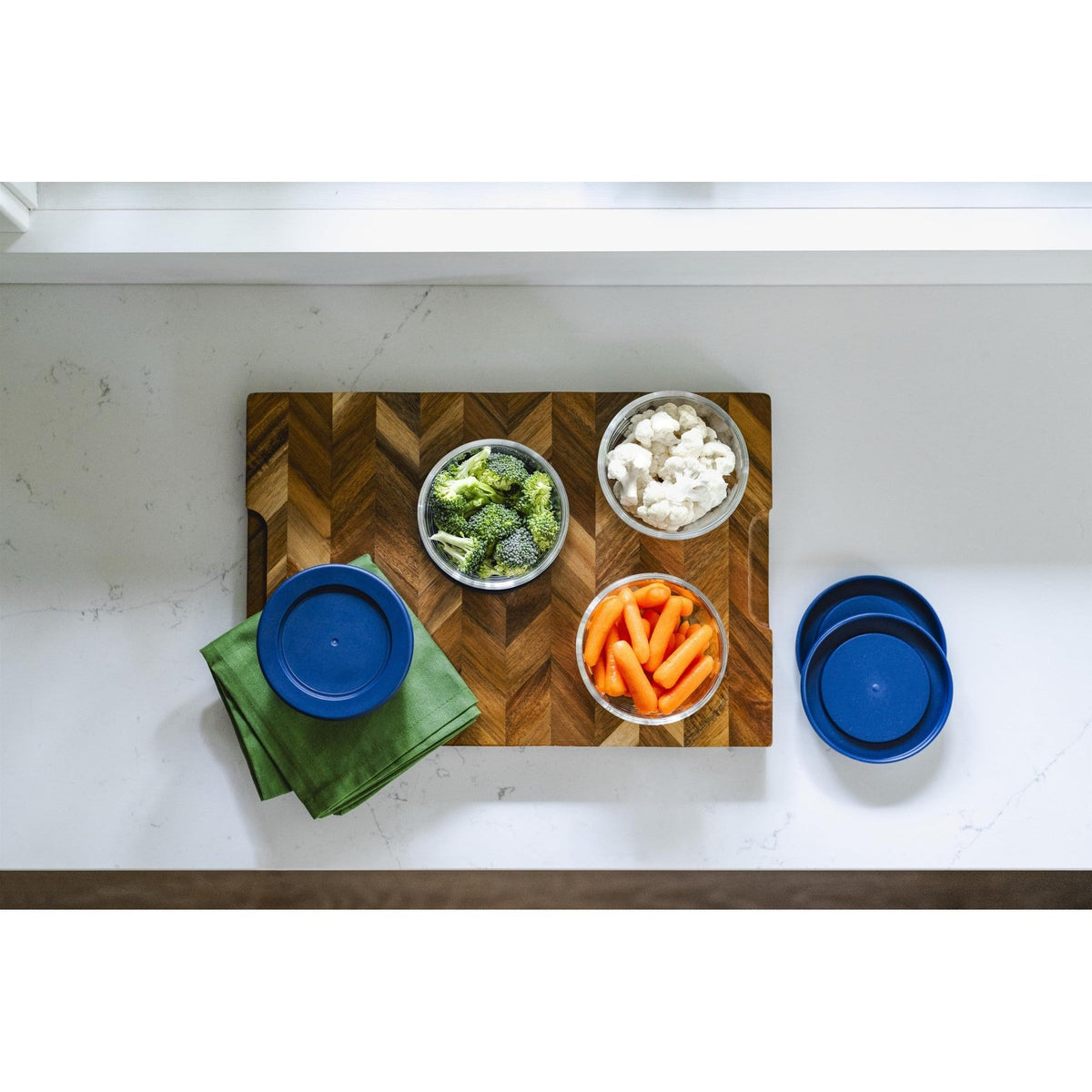 Set of 8 round glass storage containers with blue lids, 7oz capacity, from Dura Living, perfect for kitchen organization.