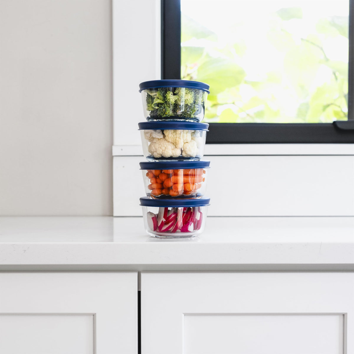 Set of 8 round glass storage containers with blue lids, 7oz capacity, durable Dura Living glassware for kitchen organization.