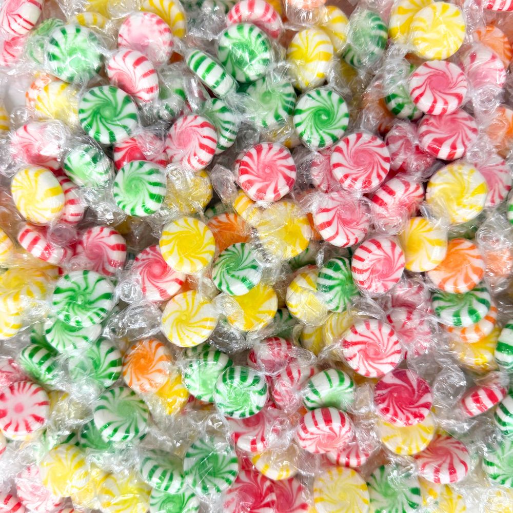 Assorted hard candies in bright wrappers from Candy In Bulk, displayed in a large bulk value bag.