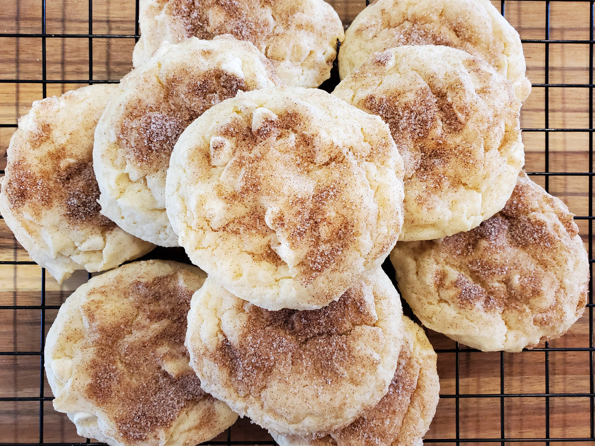 White chocolate snickerdoodle cookies from Let's Get Baked Artisan Desserts, a dozen freshly baked cookies with white chocolate chunks.