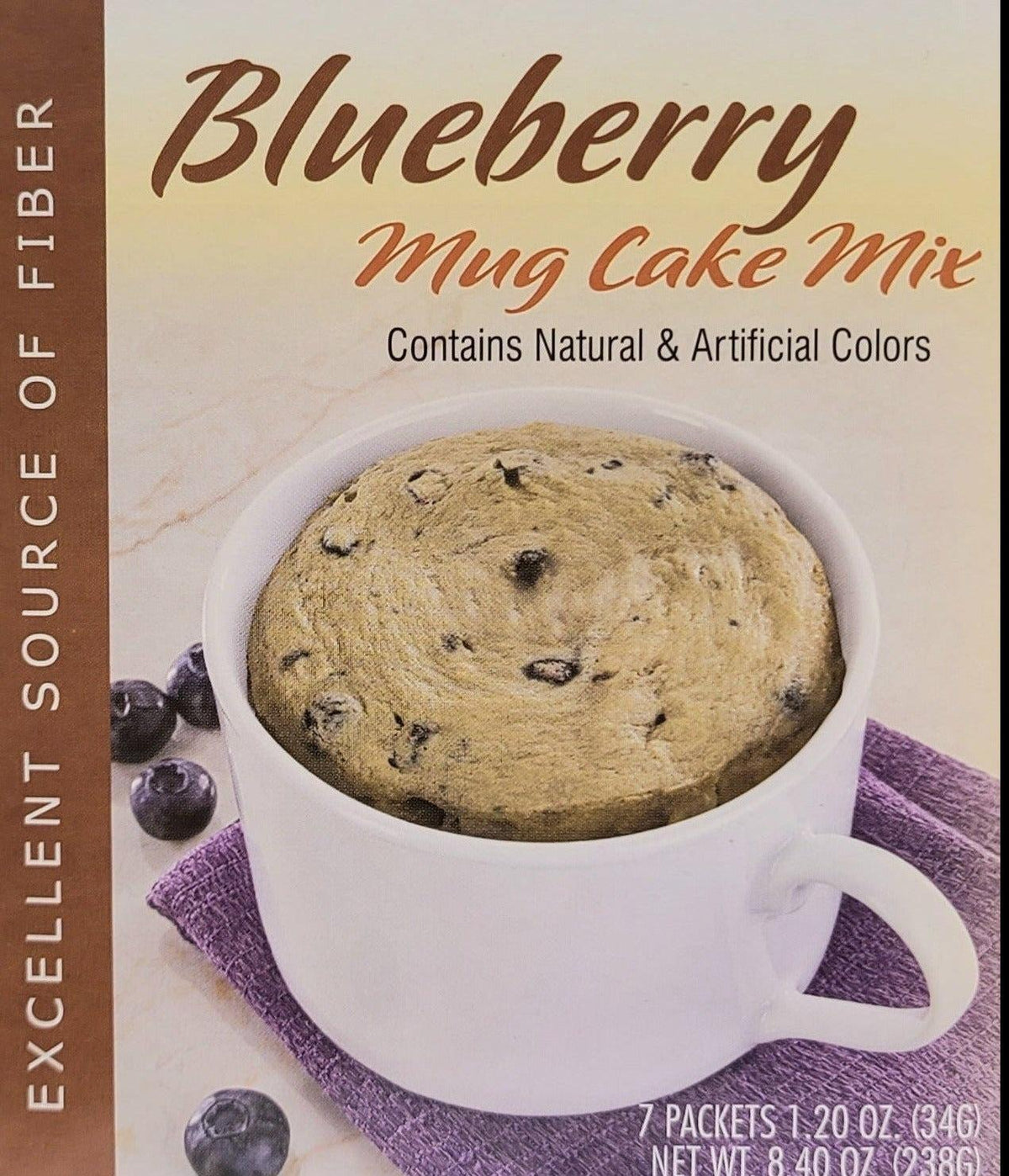 AmBari Nutrition Blueberry Mug Cake in a white mug topped with fresh blueberries, ready to eat.