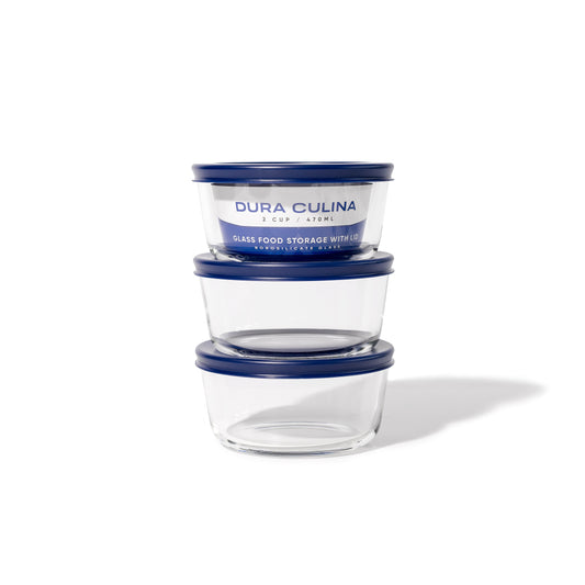 Six blue glass storage containers with lids, 16 oz round glassware set by Dura Living, featuring clear glass and blue lids.