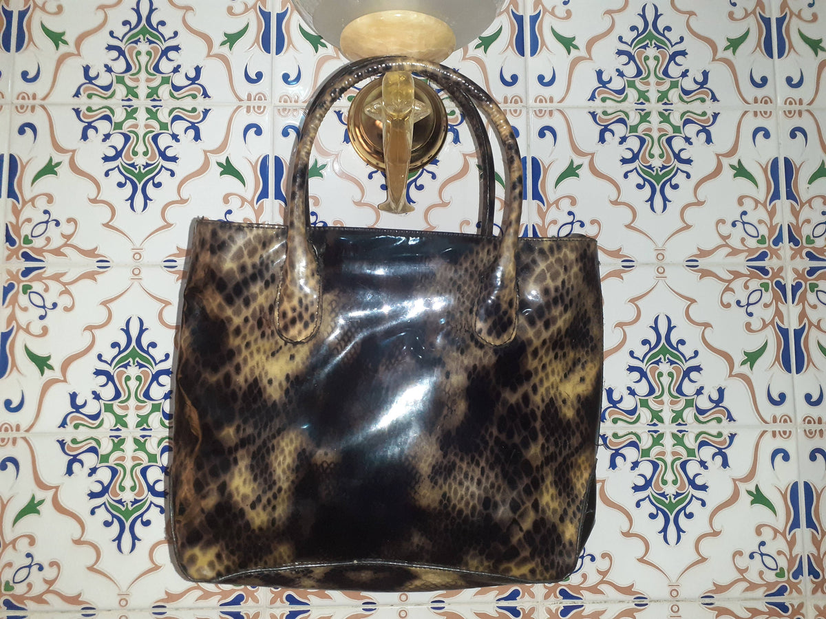 Handmade women's handbag with sturdy handles, crafted for stylish carrying and everyday use.
