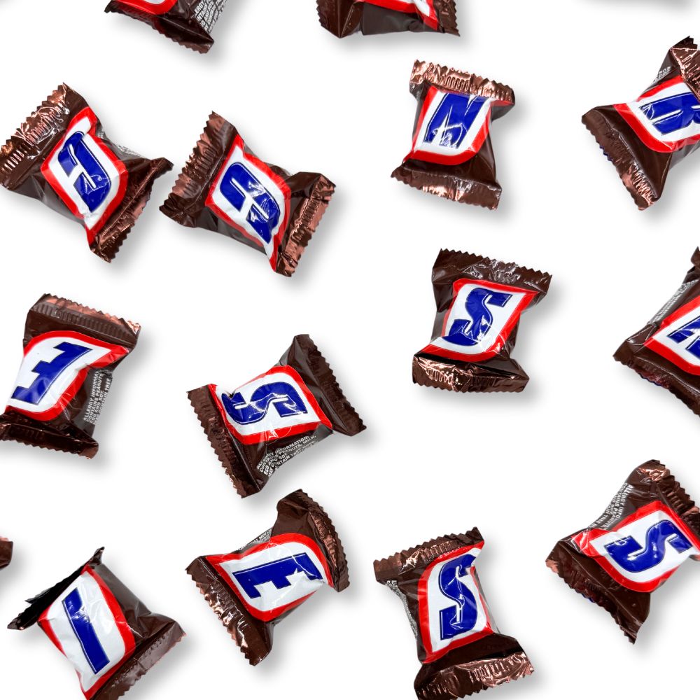 Mini Snickers chocolate candy bars from Candy In Bulk, shown in a bulk value bag, perfect for snacking or sharing