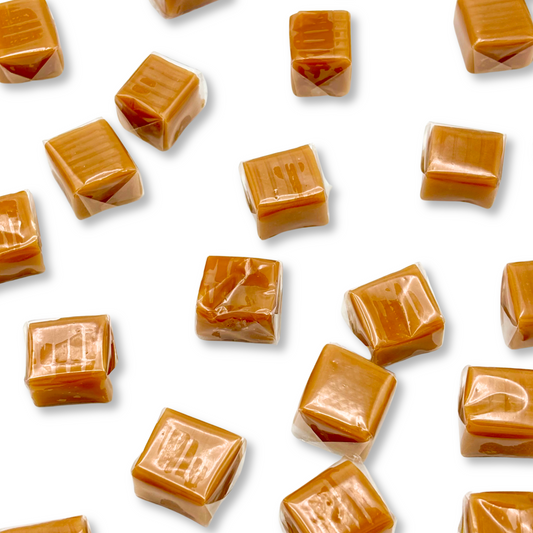 Two individually wrapped vanilla caramel squares candies from Candy In Bulk in a bulk value bag.