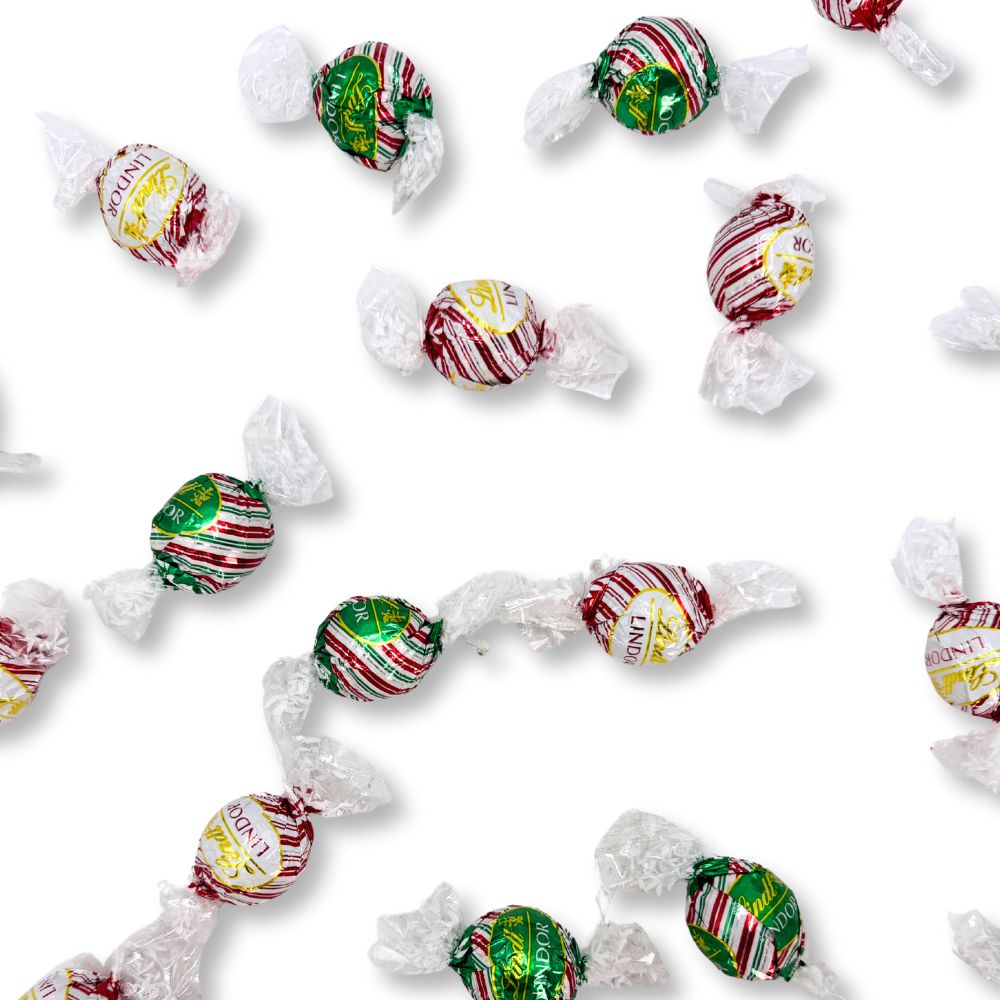 Assorted Lindt LINDOR Peppermint chocolate truffles in a bulk value bag, showcasing smooth, creamy chocolates with peppermint filling.
