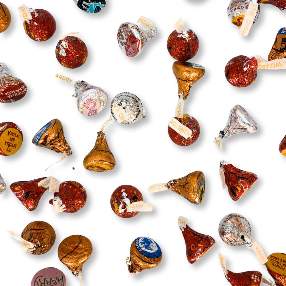 Hershey's Kisses milk chocolate candies in Harry Potter-themed foil wraps, shown in a bulk value bag from Candy In Bulk.