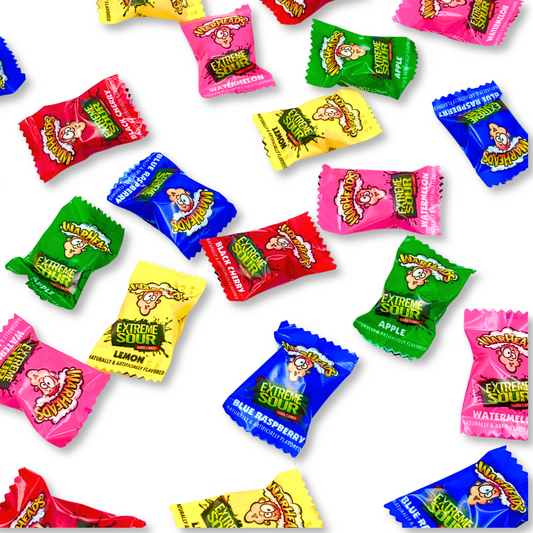 Assorted Warheads Extreme Sour Fruit Flavors hard candies in a bulk value bag by Candy In Bulk, showing colorful candies on a white surface.