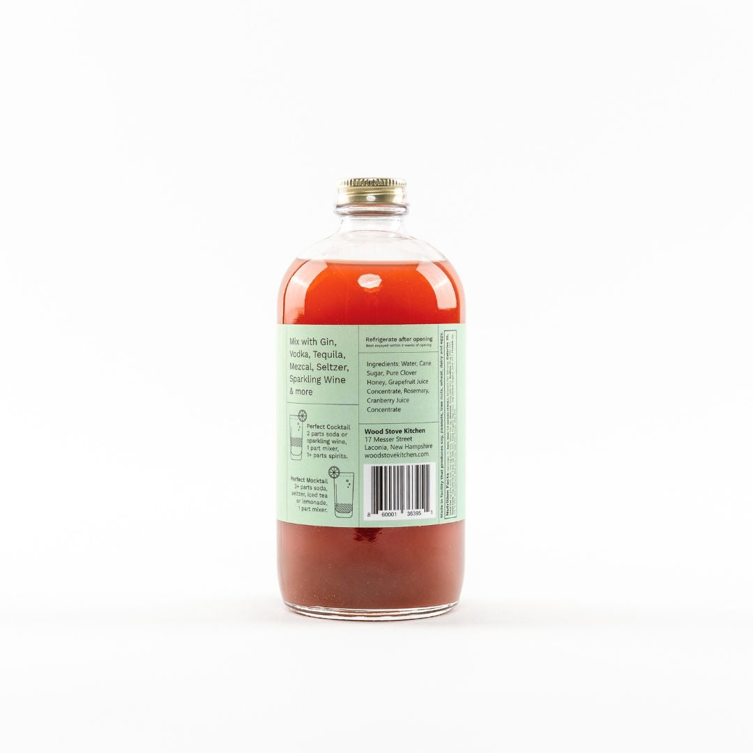 Wood Stove Kitchen grapefruit and rosemary cocktail and mocktail mixer in a 16 fl oz bottle, showing its vibrant ingredients.