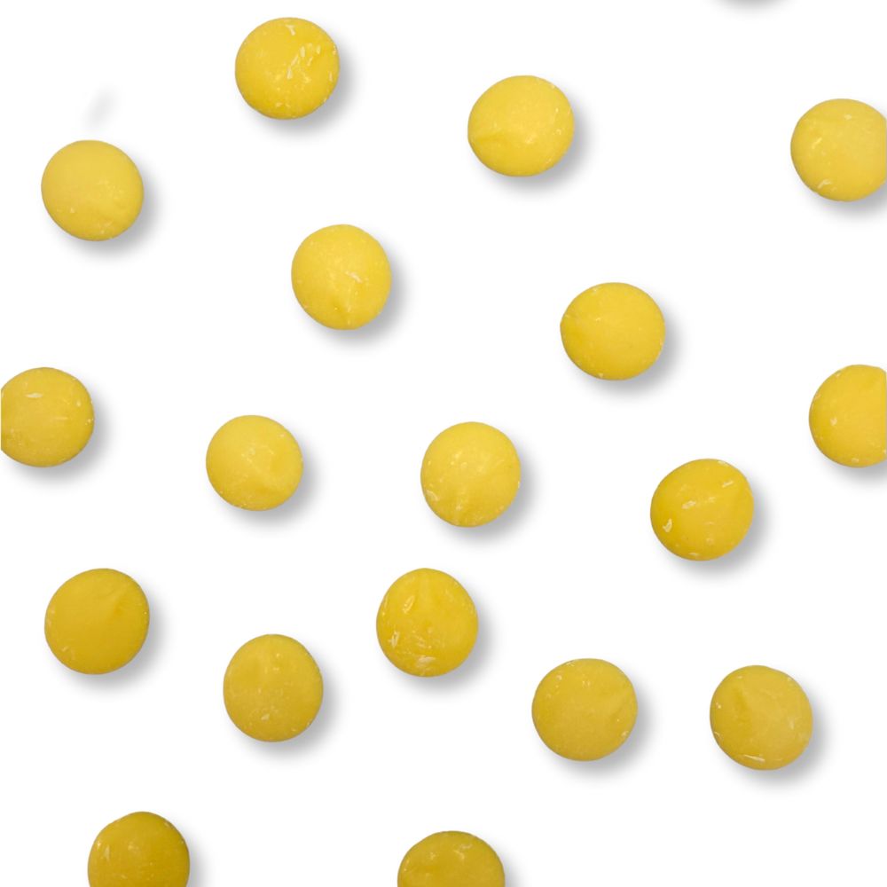 Yellow vanilla-flavored Candy In Bulk Merckens chocolate coating and melting wafers in a bulk value bag, ideal for candy making and decorating.