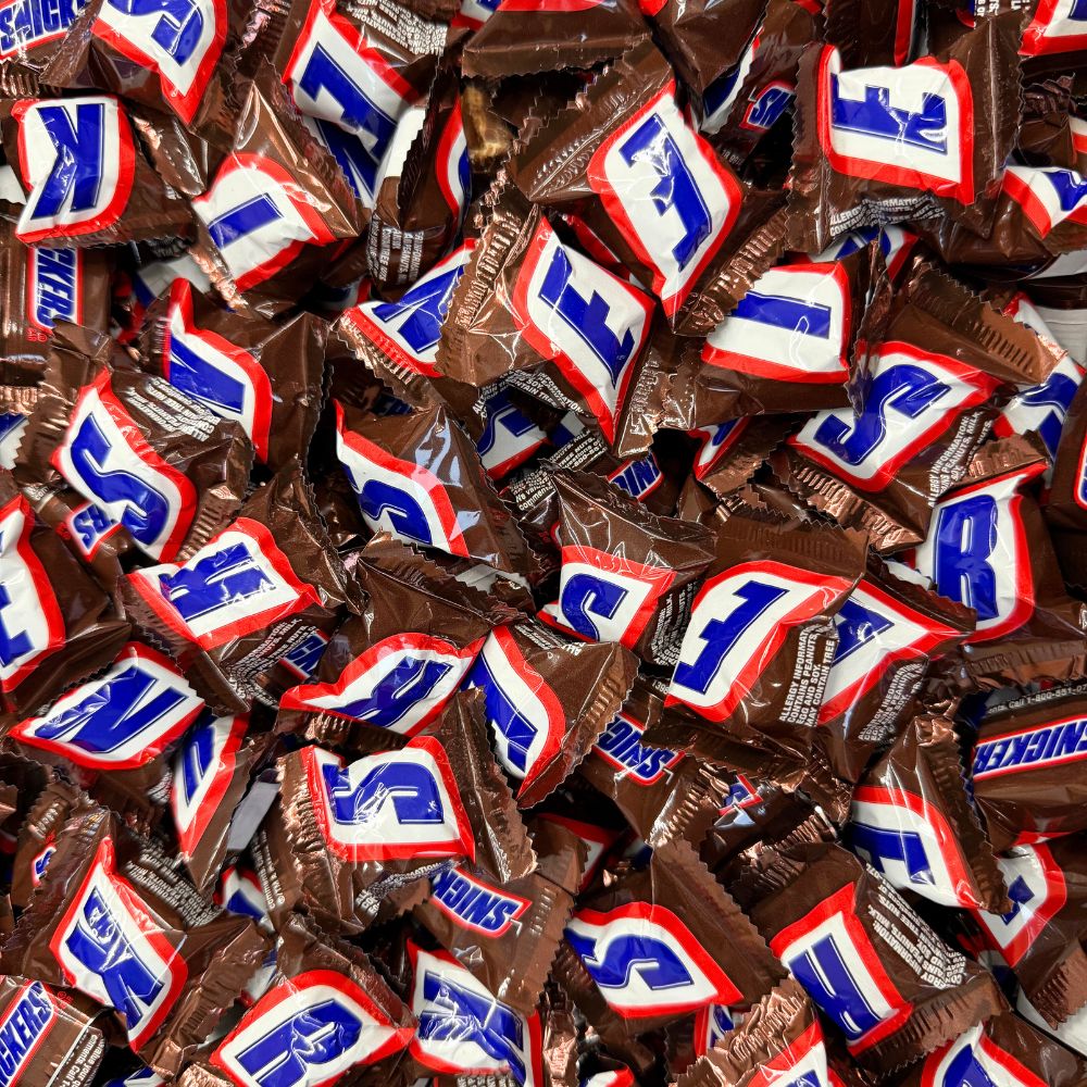 Mini Snickers chocolate candy bars from Candy In Bulk in a bulk value bag, showing individually wrapped bite-sized chocolate bars.
