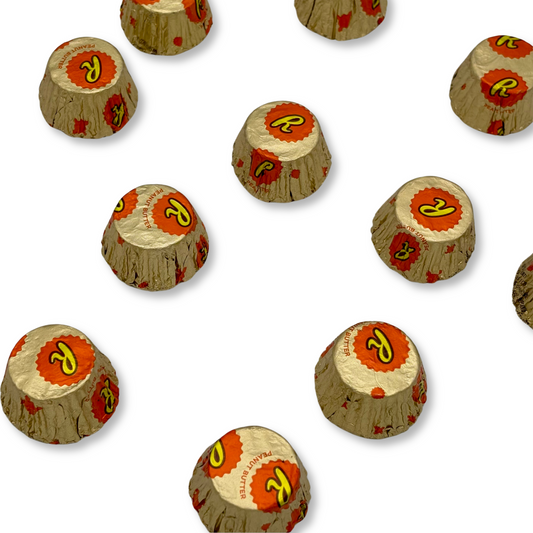 Assorted Reese's Miniature Cups Milk Chocolate and Peanut Butter candies in a bulk value bag, showing individual chocolates with peanut butter filling