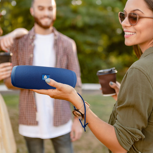 Pursonic Total Audio Freedom Collection with wireless earbuds, extended-play 360° speaker, and waterproof suction speaker on a table.