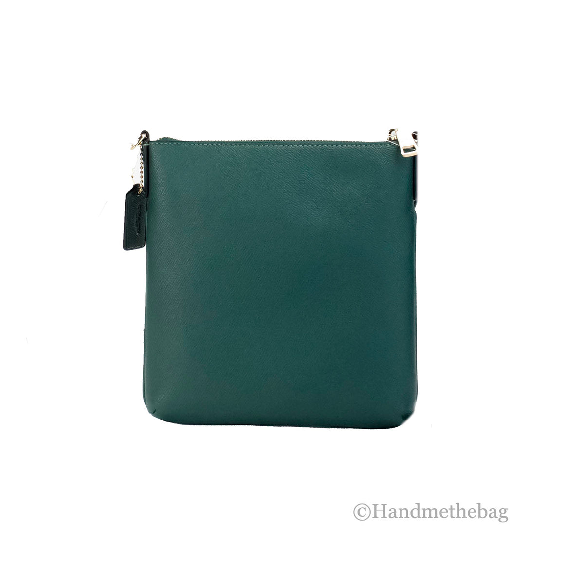 Coach Rowan Mini Dark Pine leather crossbody bag with sleek design and adjustable strap, perfect for carrying small essentials.