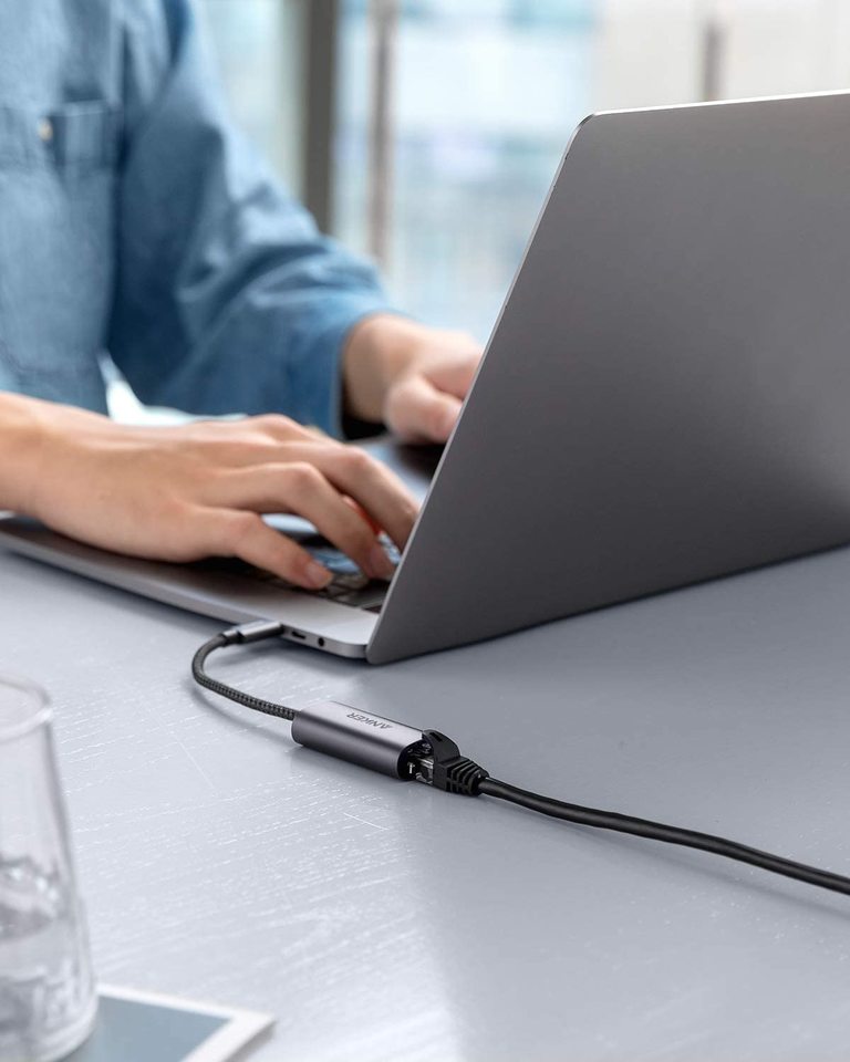 Anker PowerExpand USB-C to Gigabit Ethernet Adapter connected to a laptop, providing wired internet connection.
