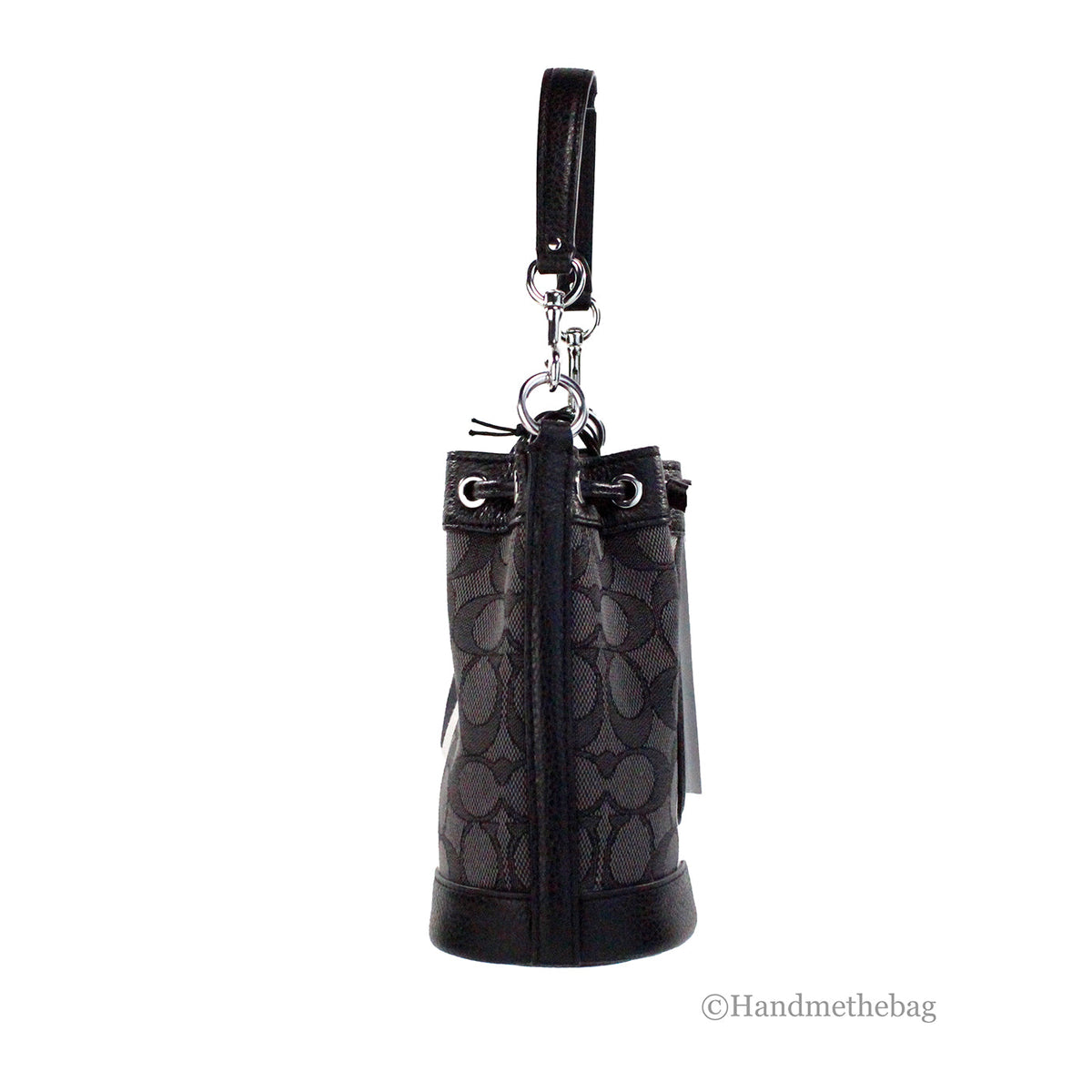 Coach Dempsey Mini black jacquard canvas patch crossbody bucket bag with adjustable strap and patchwork design.