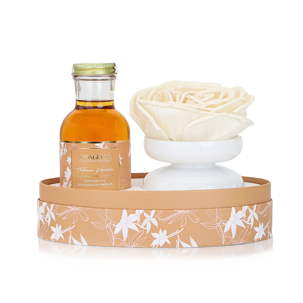Private Reserve Tobacco Vanilla home fragrance diffuser by Spongellé, featuring a sleek glass bottle with reed sticks and vanilla scent.