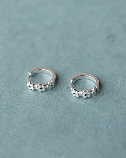 Silver In Bloom huggie hoop earrings by Downeast featuring delicate floral design and small hoop style.