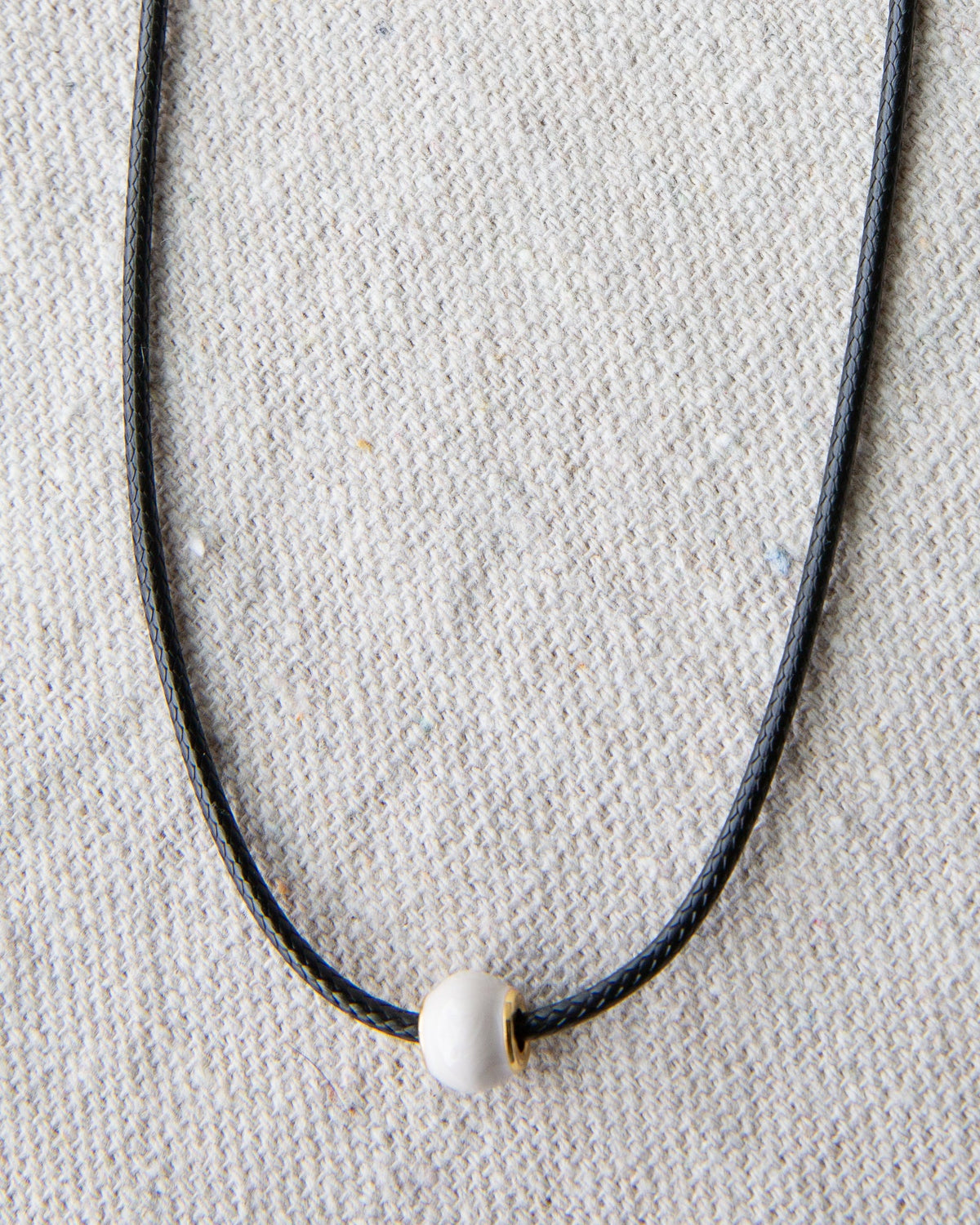 Downeast pearl and cord necklace featuring elegant white pearls on a stylish cord, perfect for casual or formal wear.