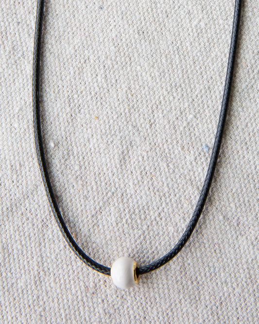 Downeast pearl and cord necklace featuring elegant white pearls on a stylish cord, perfect for casual or formal wear.