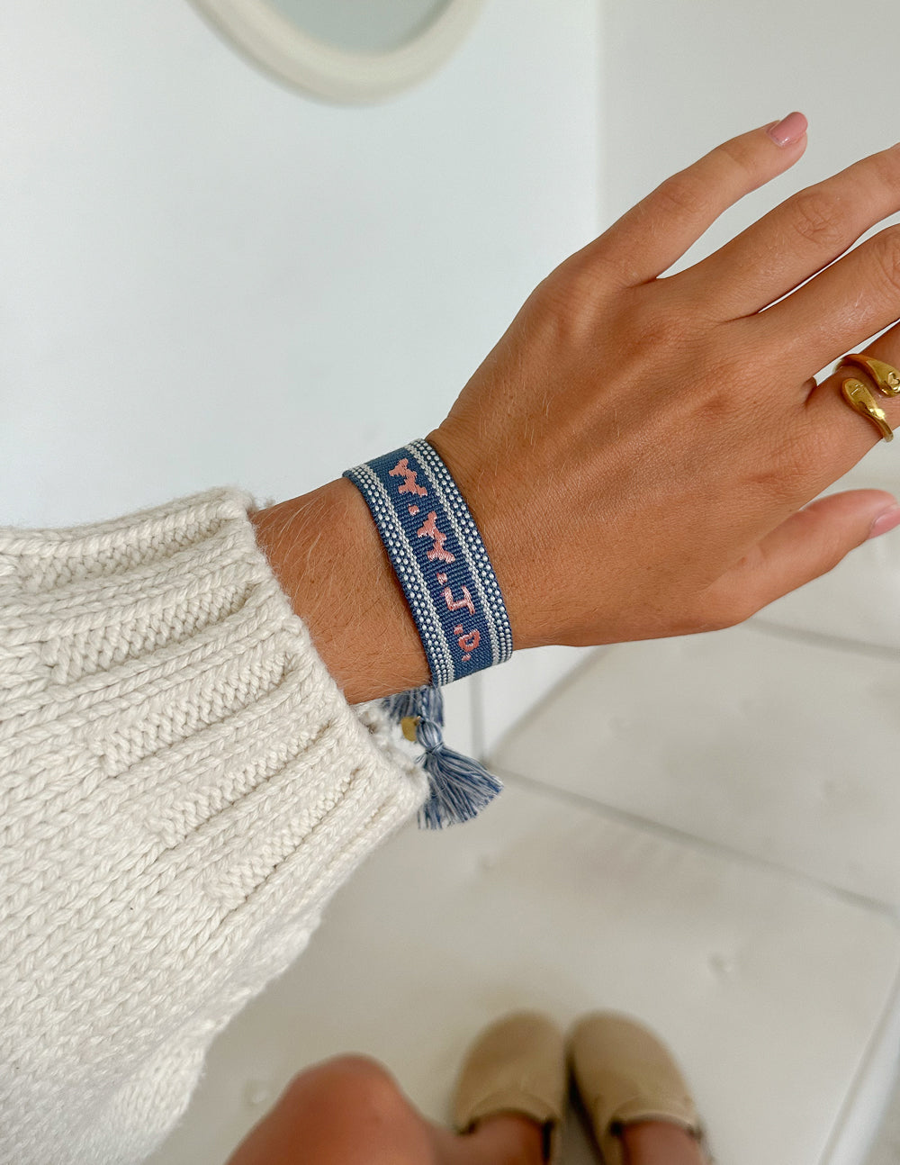 Blue WWJD embroidered wristband bracelet by Elevated Faith featuring blue fabric with white embroidered "WWJD" text.