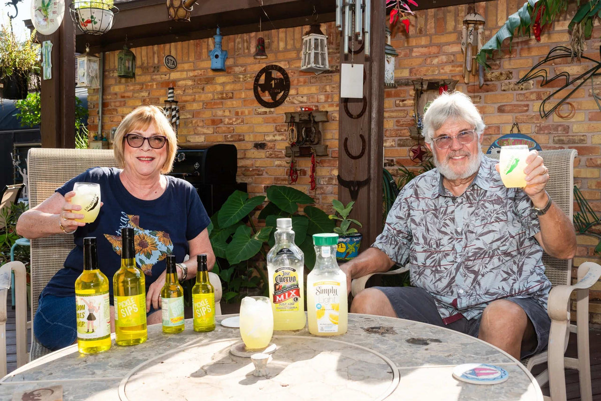 Cinderosa Ranch Pickle Sips Sweet Heat in 10 fl oz bottle, featuring colorful label and cap, on a rustic background.
