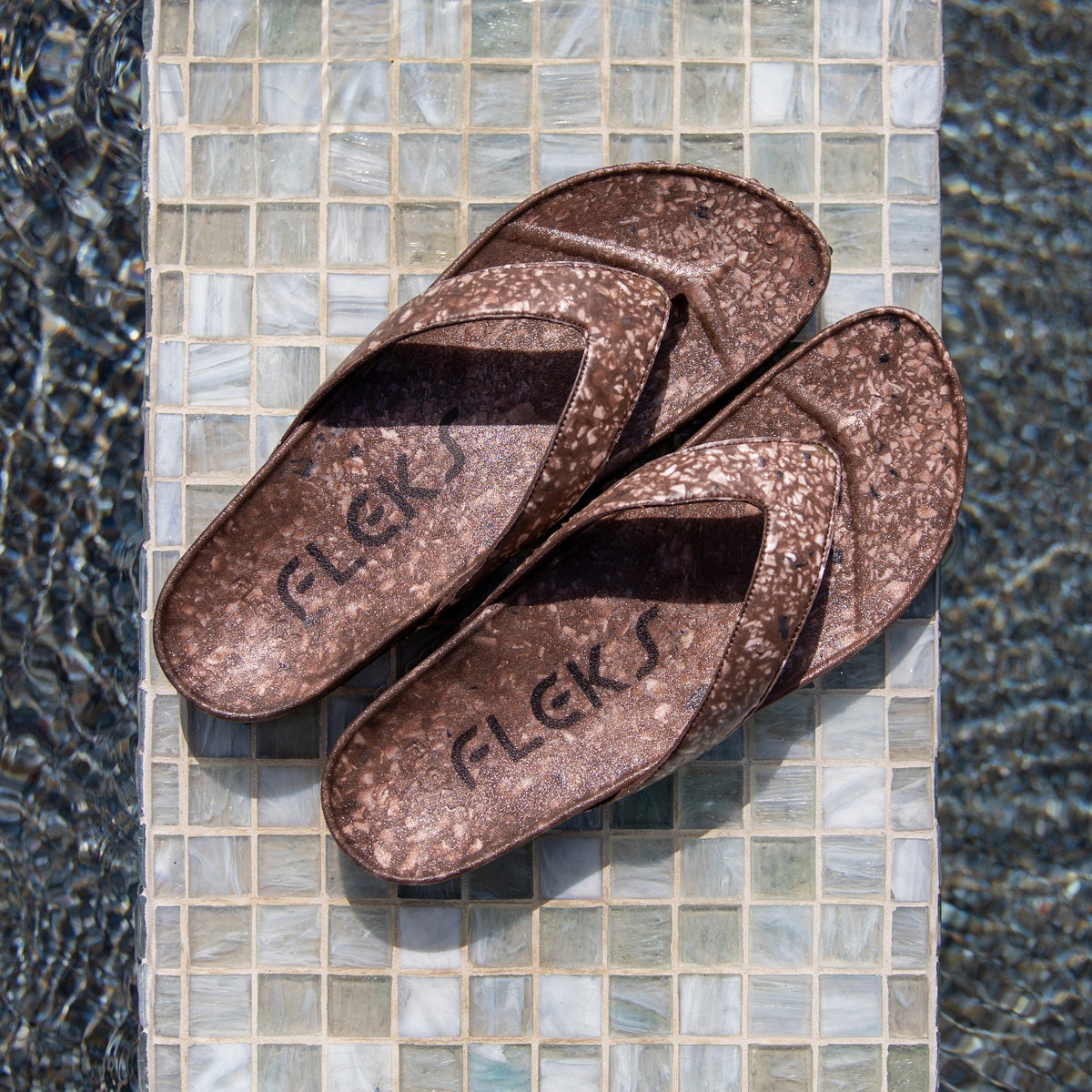 Fleks West Beach Flip Flop with coconut shell design, featuring tan straps and a casual beach-ready style.