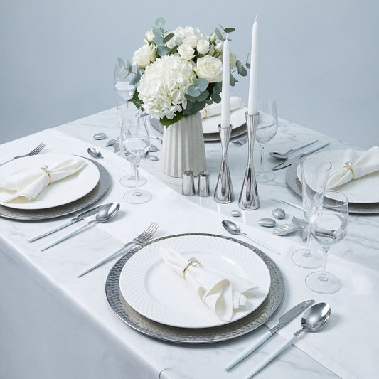 Maison Charlo 7-piece white table setting set with placemats, napkins, napkin rings, and a table runner for elegant dining.