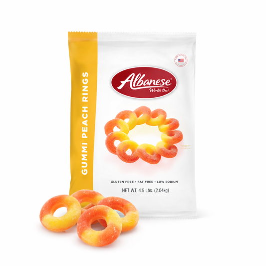 Colorful Albanese Peach Rings gummy candies from Candy In Bulk displayed in a clear bowl, showcasing their peach flavor and chewy texture.