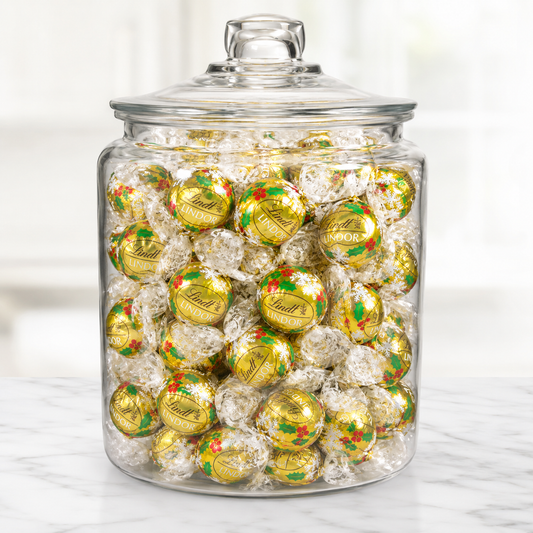 White Lindt LINDOR chocolate truffles in holiday wrappers, bulk value bag from Candy In Bulk, showcasing smooth white chocolate.