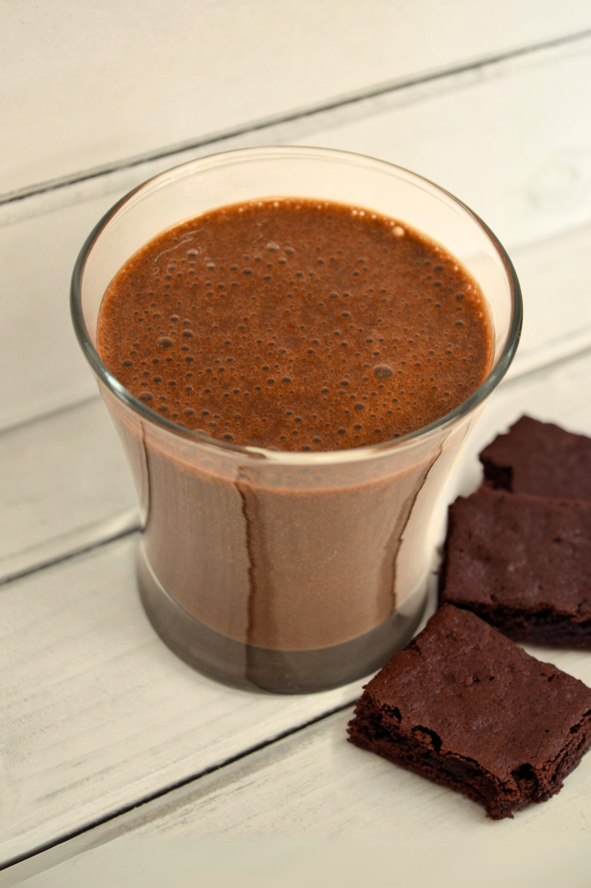 Chocolate Brownie Shake by AmBari Nutrition featuring a creamy chocolate and brownie-flavored shake in a glass.