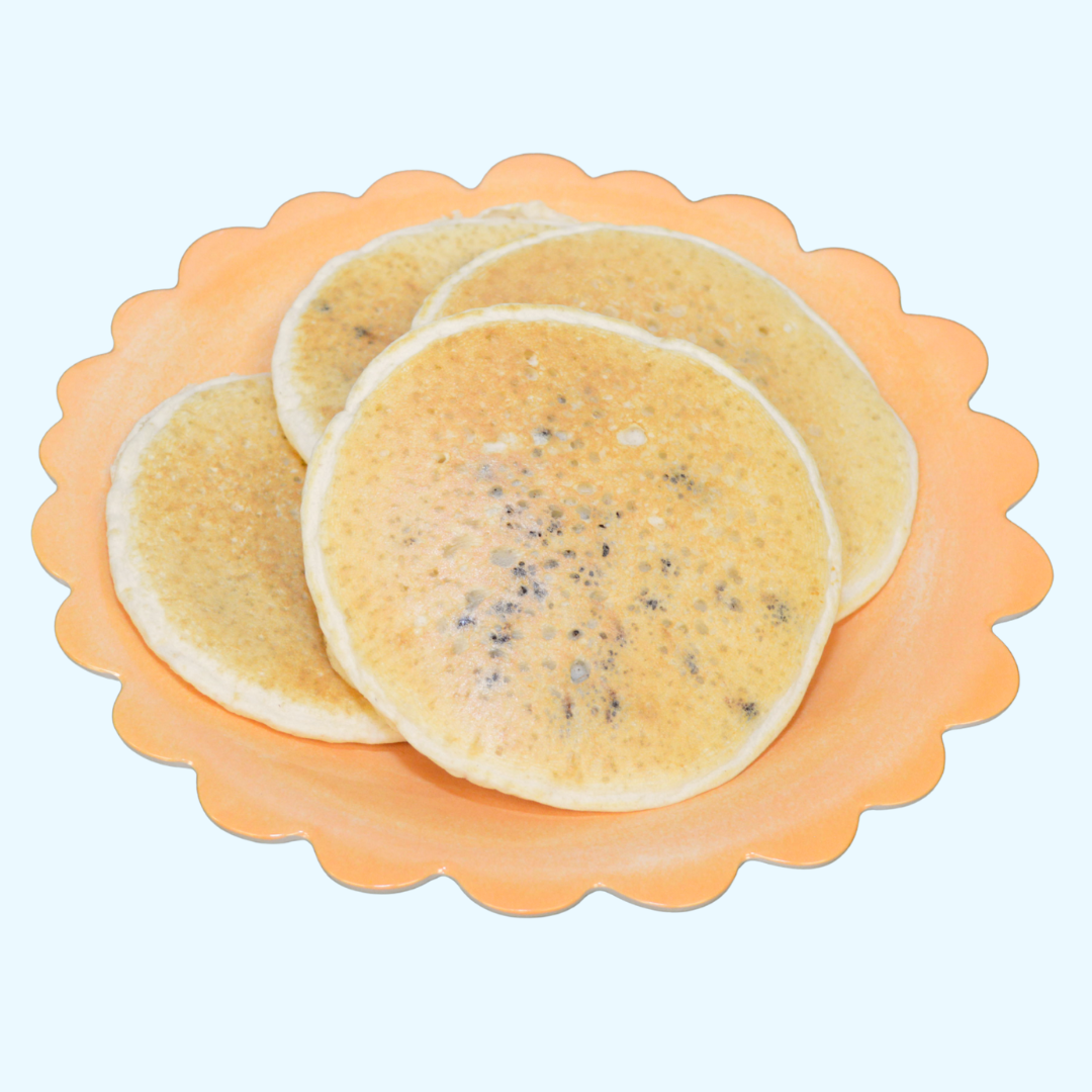 AmBari Nutrition chocolate chip protein pancakes, golden-brown stacked breakfast food with chocolate chips visible in the image.