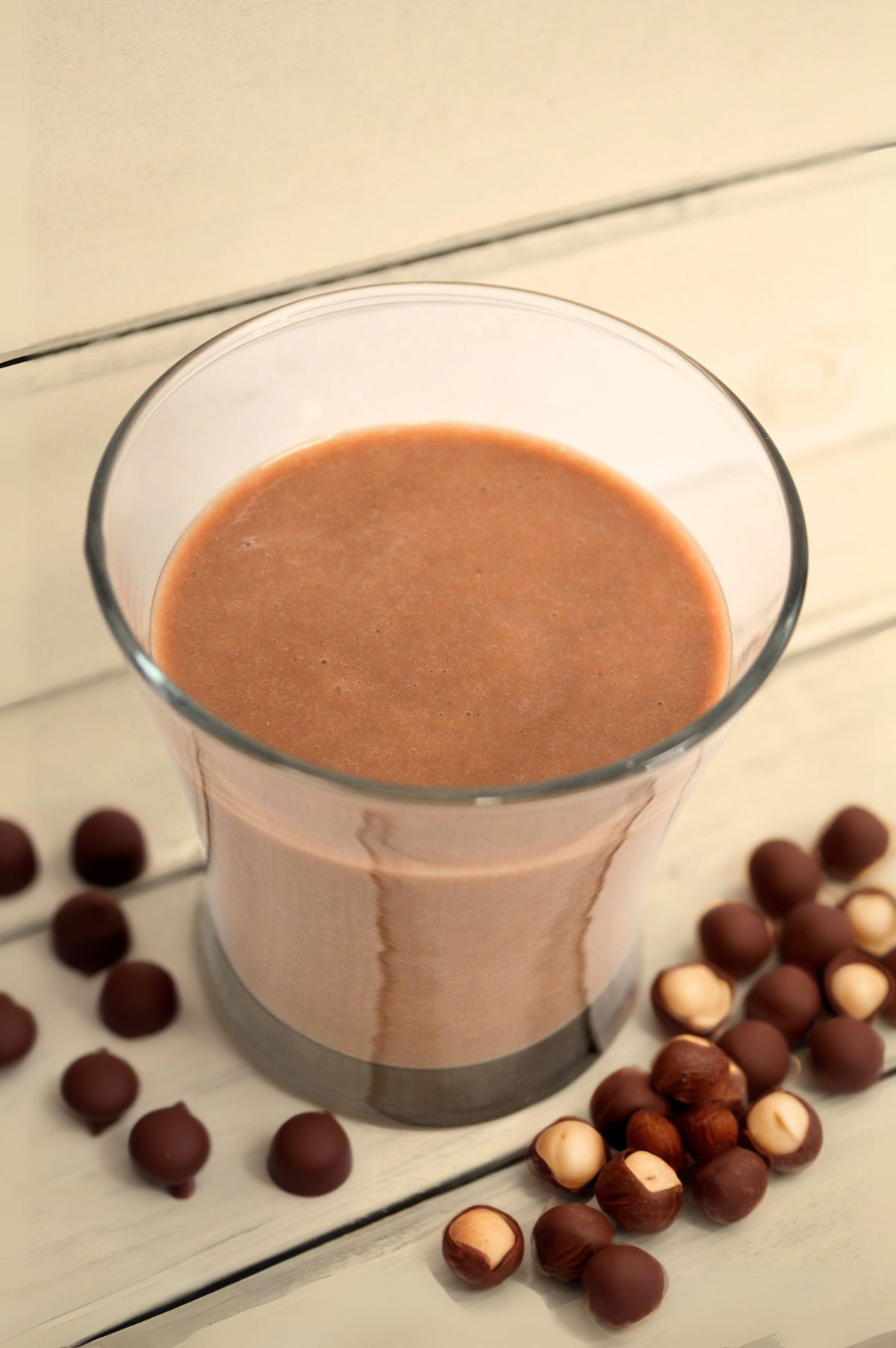 Chocolate hazelnut protein shake by AmBari Nutrition in a glass, showcasing creamy texture and rich chocolate hazelnut flavor.