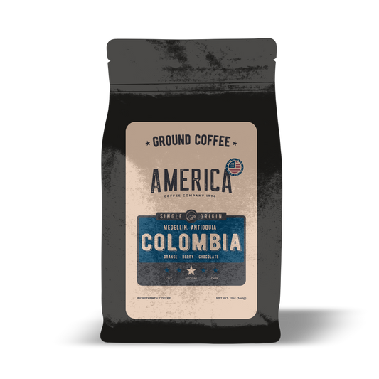 Ground Colombia single origin coffee by America Supply Company LLC, showing fresh roasted coffee grounds in a clear bag.