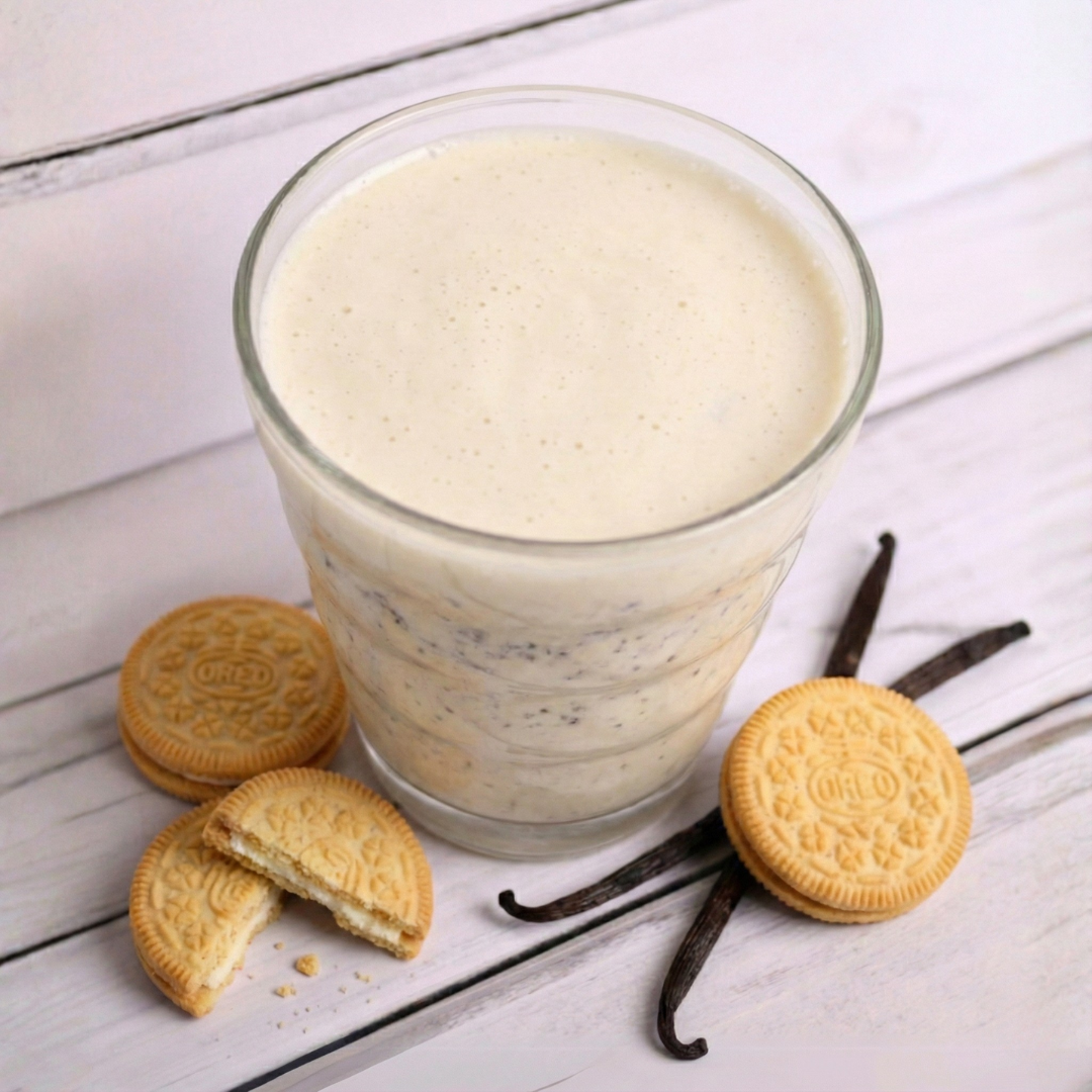 Creamy cookie shake from AmBari Nutrition with cookies and cream flavor in a glass, topped with whipped cream and cookie crumbles.