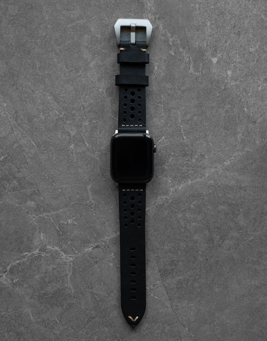 Close-up of Robust racing leather strap with detailed stitching and sturdy buckle, showcasing craftsmanship and premium leather material.