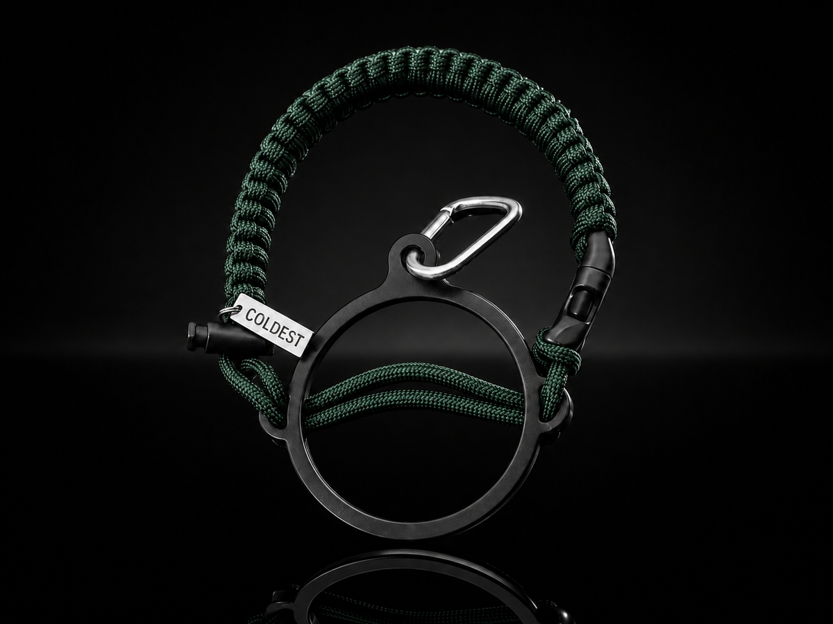 Dark green and black Coldest Paracord handle accessory with durable woven design on a dark background