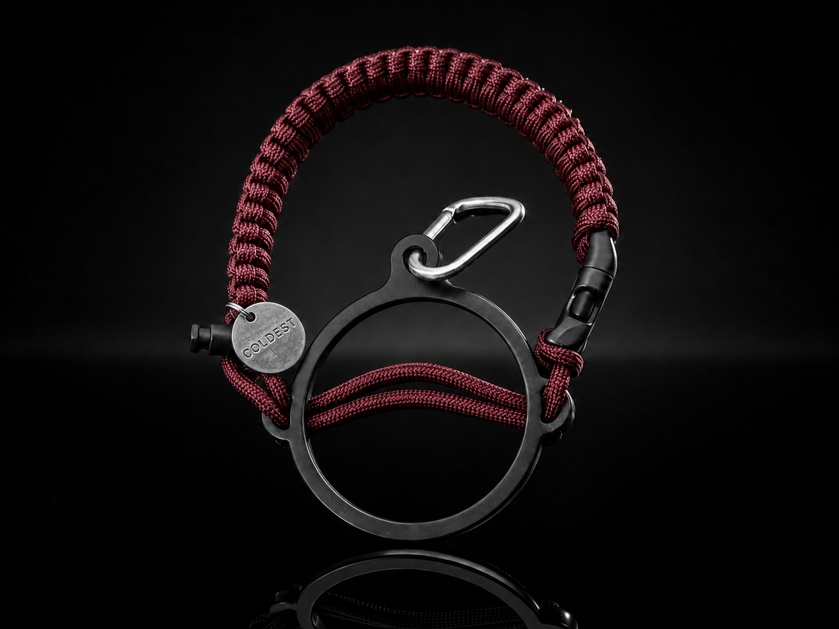 Dark pink and black Coldest Paracord Handle accessory with durable woven design on a dark background.