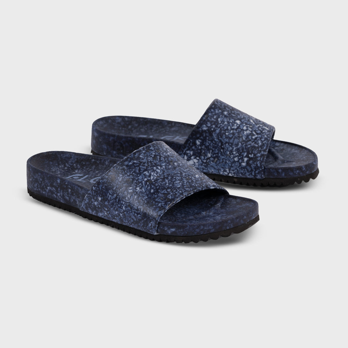 Fleks East Beach Slide in deep blue sea color, featuring a comfortable slip-on design with textured sole and casual beach style.