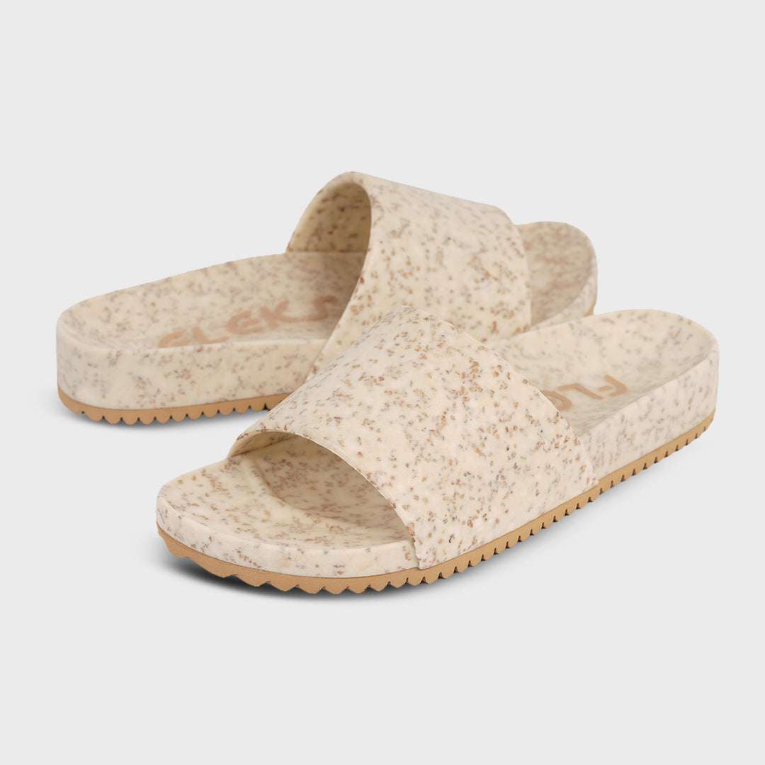 Fleks East Beach Slide in white sand, showcasing comfortable slide sandals designed for beachwear and casual summer style.