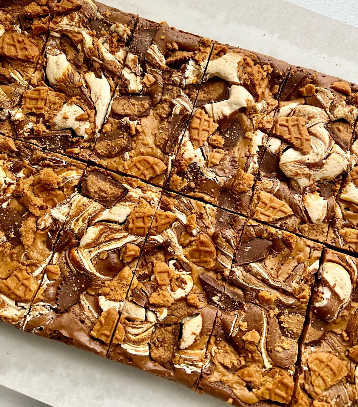 Let's Get Baked Artisan Desserts FlufferNutter Brownie, a rich chocolate cake with peanut butter filling and creamy frosting.