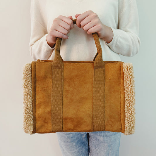 Ellisonyoung Tote Crossbody Bag with handles in neutral fabric, showing its spacious design and sturdy straps.