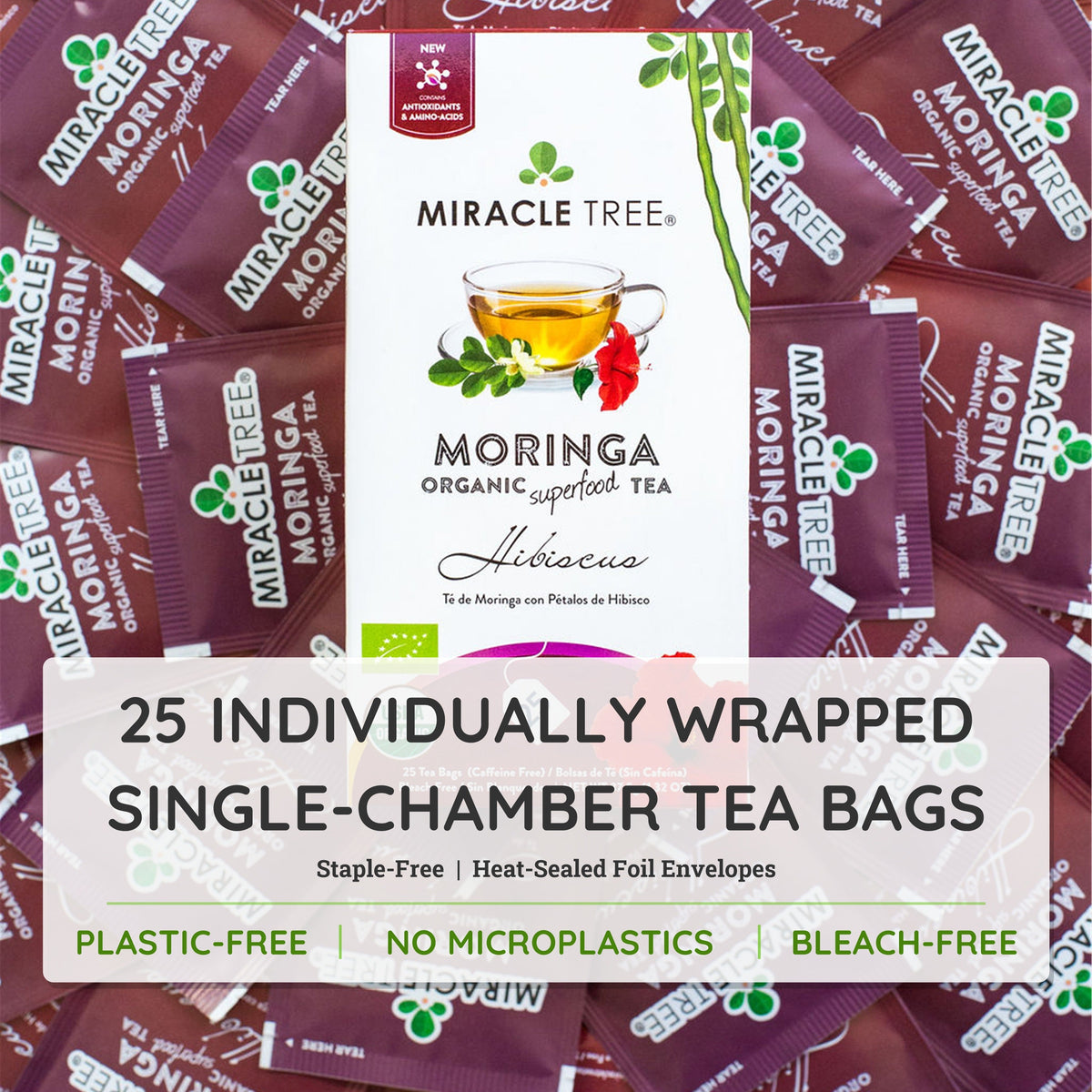 Organic Moringa and hibiscus herbal tea by Miracle Tree, caffeine-free, in a clear glass cup with blooming tea leaves and vibrant hibiscus.