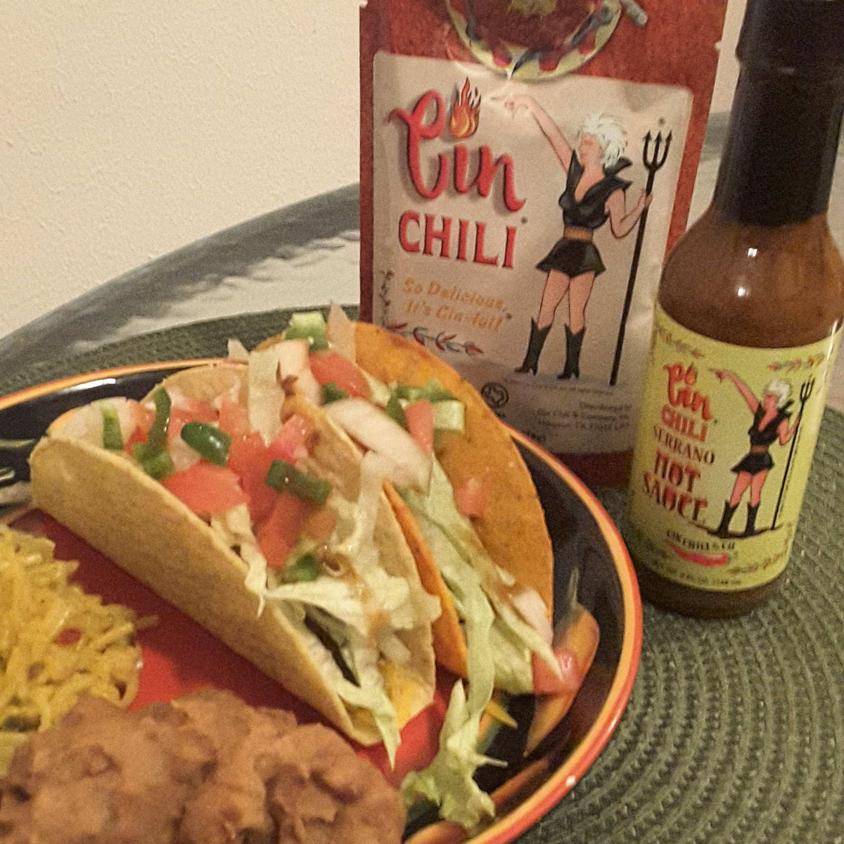 Cinderosa Ranch Cin Chili Seasoning and Serrano Hot Sauce combo in a jar and bottle on a white background