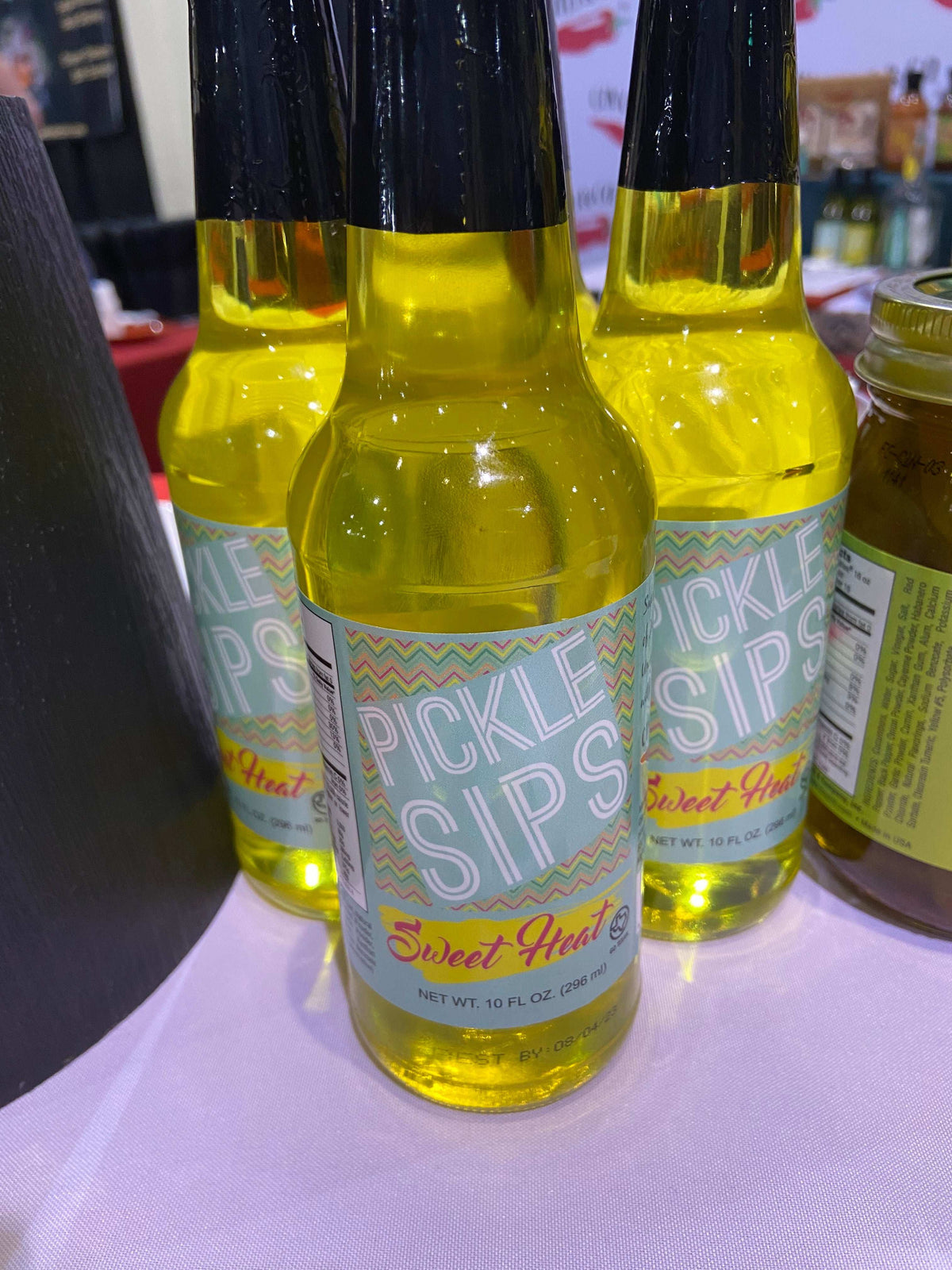 Cinderosa Ranch Pickle Sips Sweet Heat 10 fl oz bottle featuring spicy and sweet pickle-flavored beverage in clear container