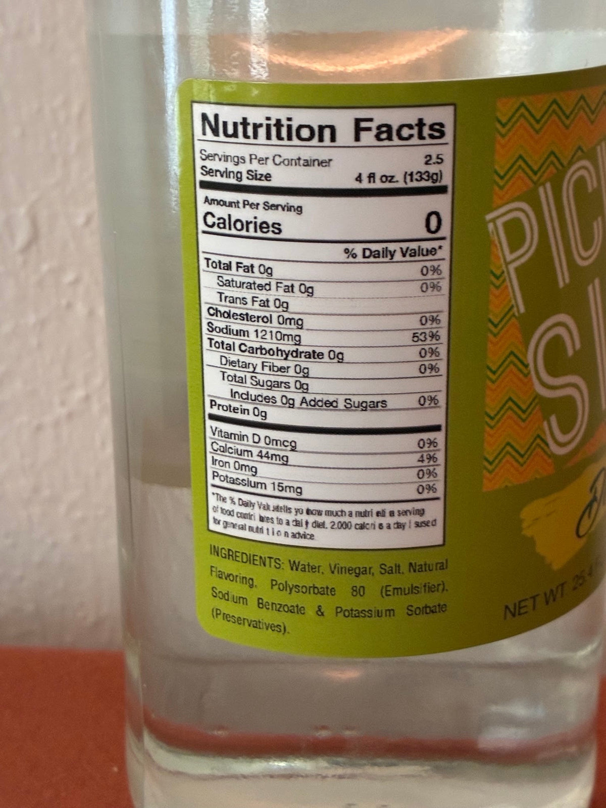 Cinderosa Ranch Pickle Sips Dill liquid in 25.4 fl oz bottle, featuring a clear label with dill pickle imagery and branding.