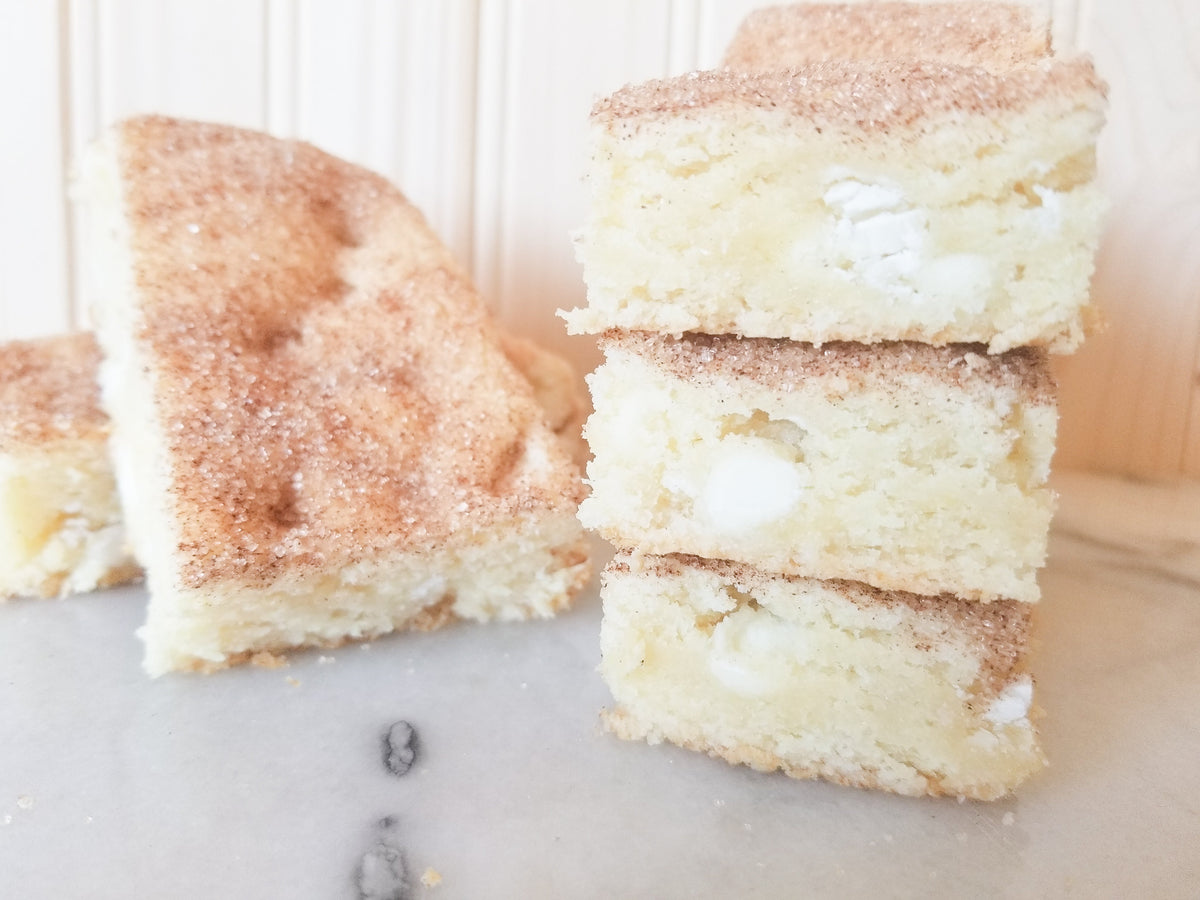 White chocolate snickerdoodle blondies from Let's Get Baked Artisan Desserts, showing creamy, golden dessert bars with cinnamon sugar topping.